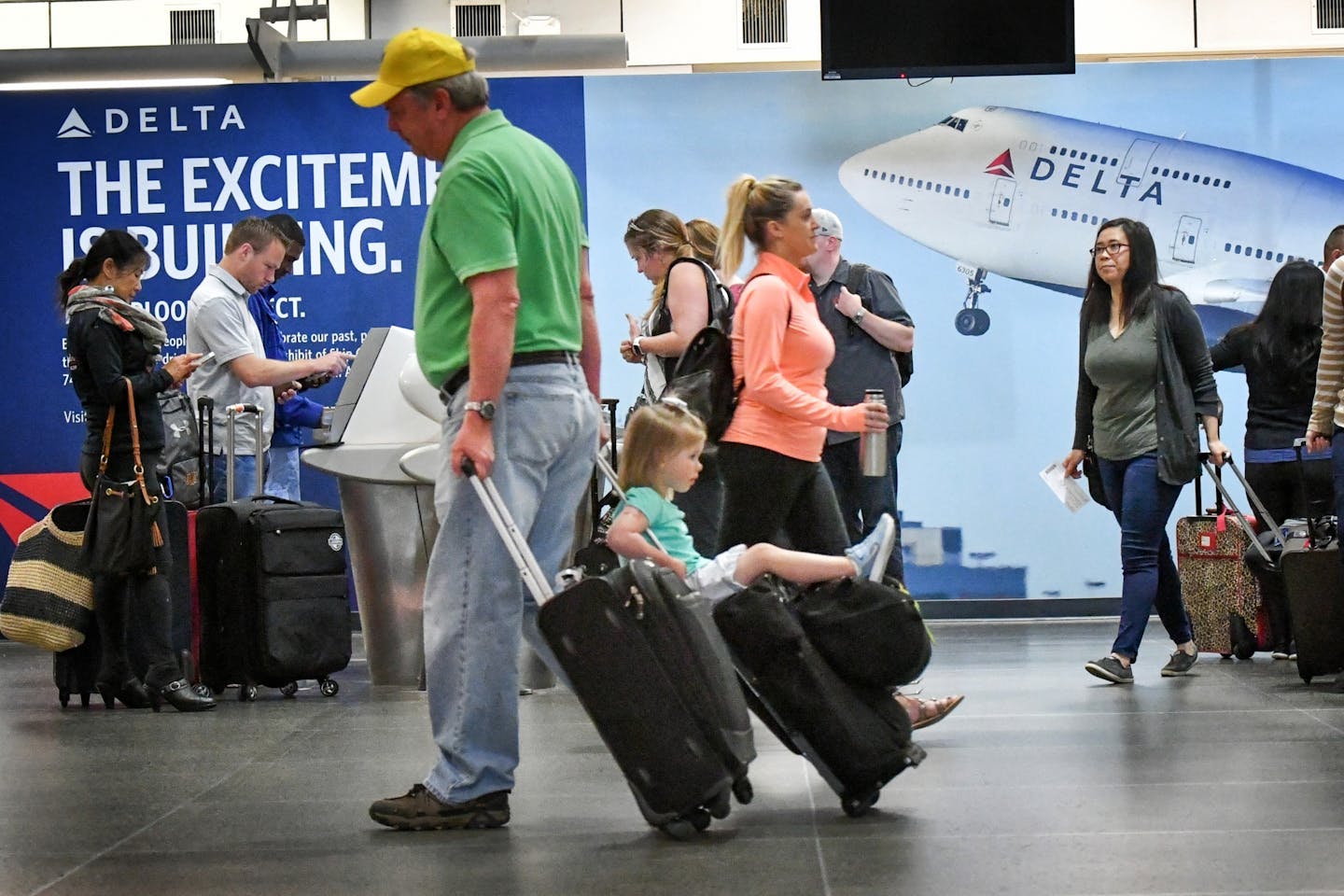 A little girl hitched a ride on a rolling suitcase Friday morning at Minneapolis St. Paul International Airport Terminal 1.