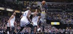 Indiana Pacers guard Darren Collison (2) pulls up to shoot over Minnesota Timberwolves defenders Jeff Teague (0) and Anthony Tolliver (43) during the 