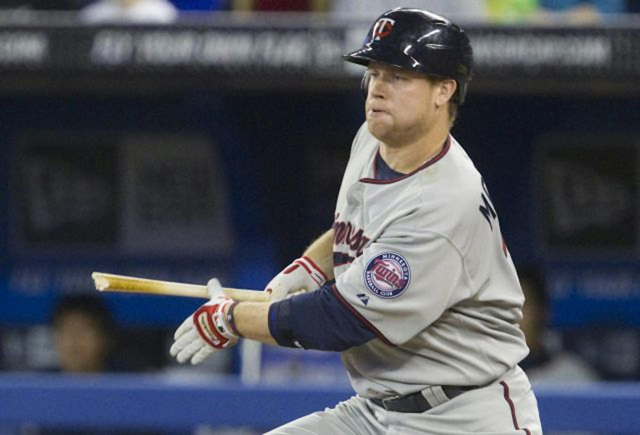 Minnesota Twins' Justin Morneau hits a broken-bat single during eighth-inning MLB baseball game action against the Toronto Blue Jays in Toronto, Sunday, April 3, 2011. The Twins defeated the Blue Jays 4-3.