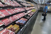 A shopper surveys the overflowing selection of packaged meat in a grocery early Monday, April 27, 2020, in southeast Denver.