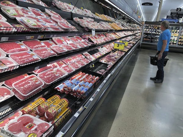 A shopper surveys the overflowing selection of packaged meat in a grocery early Monday, April 27, 2020, in southeast Denver.