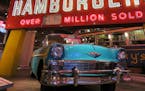 A Chevy convertible sits beneath a 1960 McDonald’s sign in an exhibit on “Driving in America” at the Henry Ford Museum.