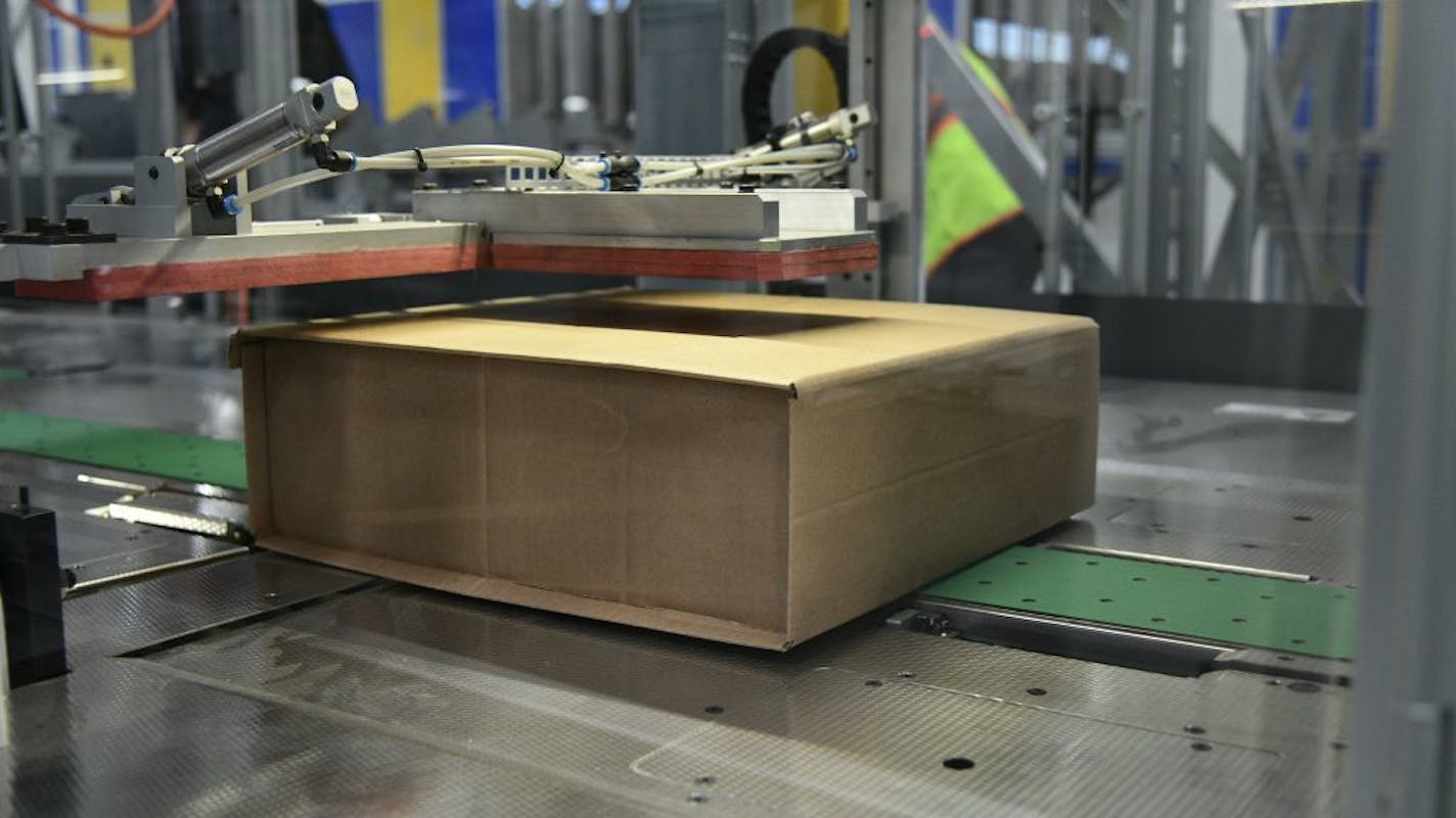 A machine at the Best Buy warehouse in Compton, Calif., builds shipping boxes to the exact size of the item, eliminating waste and the need for plastic bubble.