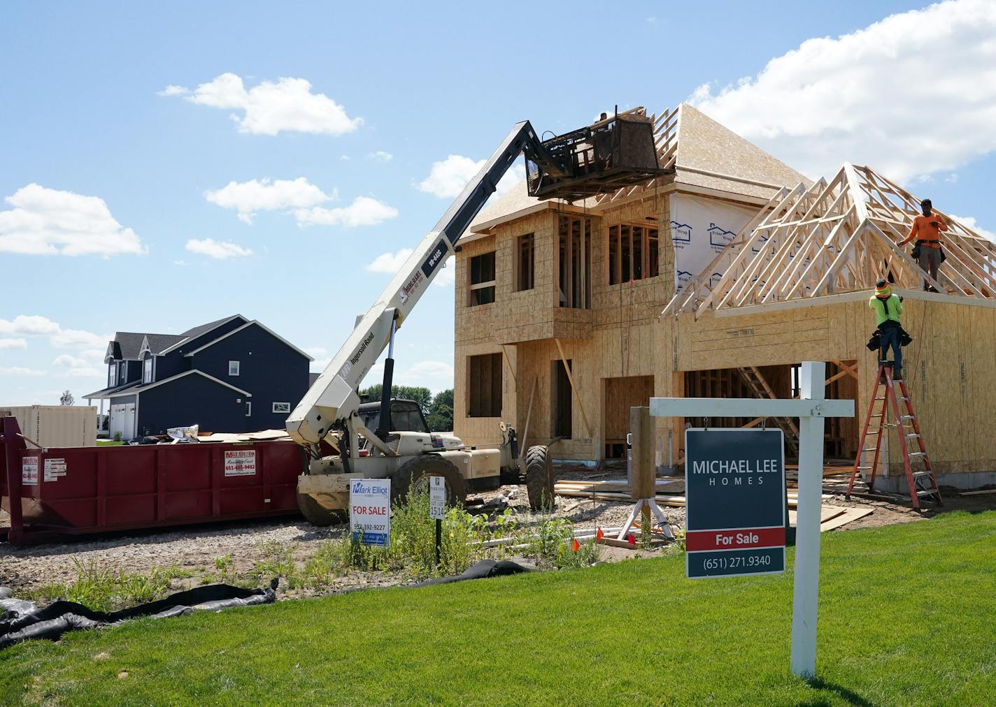 Crews worked on a home under construction in the Bailey Meadows development Friday in Newport. ] ANTHONY SOUFFLE • anthony.souffle@startribune.com Construction crews worked on several single family home developments Friday, July 31, 2020 in Newport, Minn.