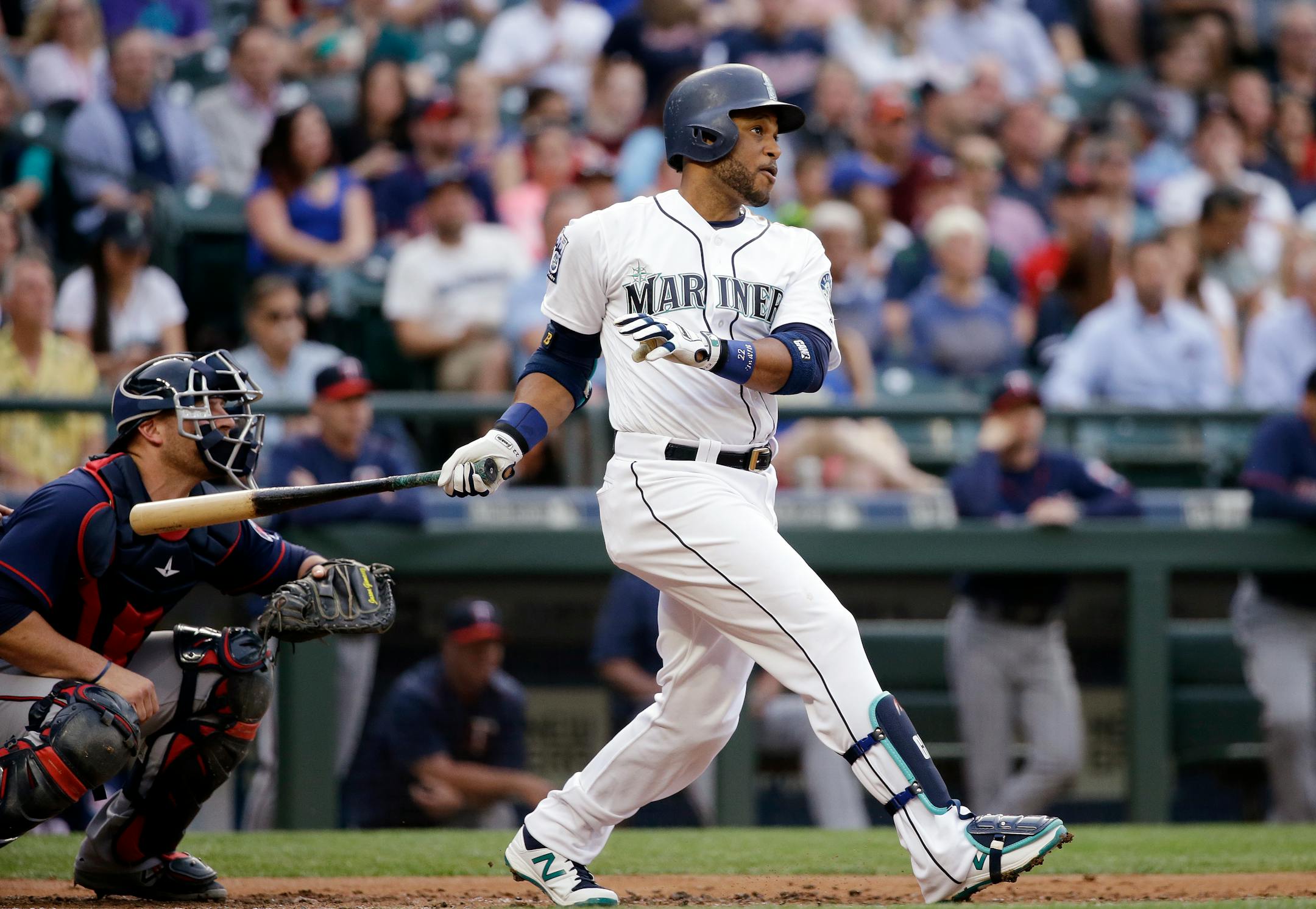 Seattle Mariners' Robinson Cano and Minnesota Twins catcher Chris Gimenez watch the path of Cano's three-run home run in the first inning of a baseball game Tuesday, June 6, 2017, in Seattle. (AP Photo/Elaine Thompson)