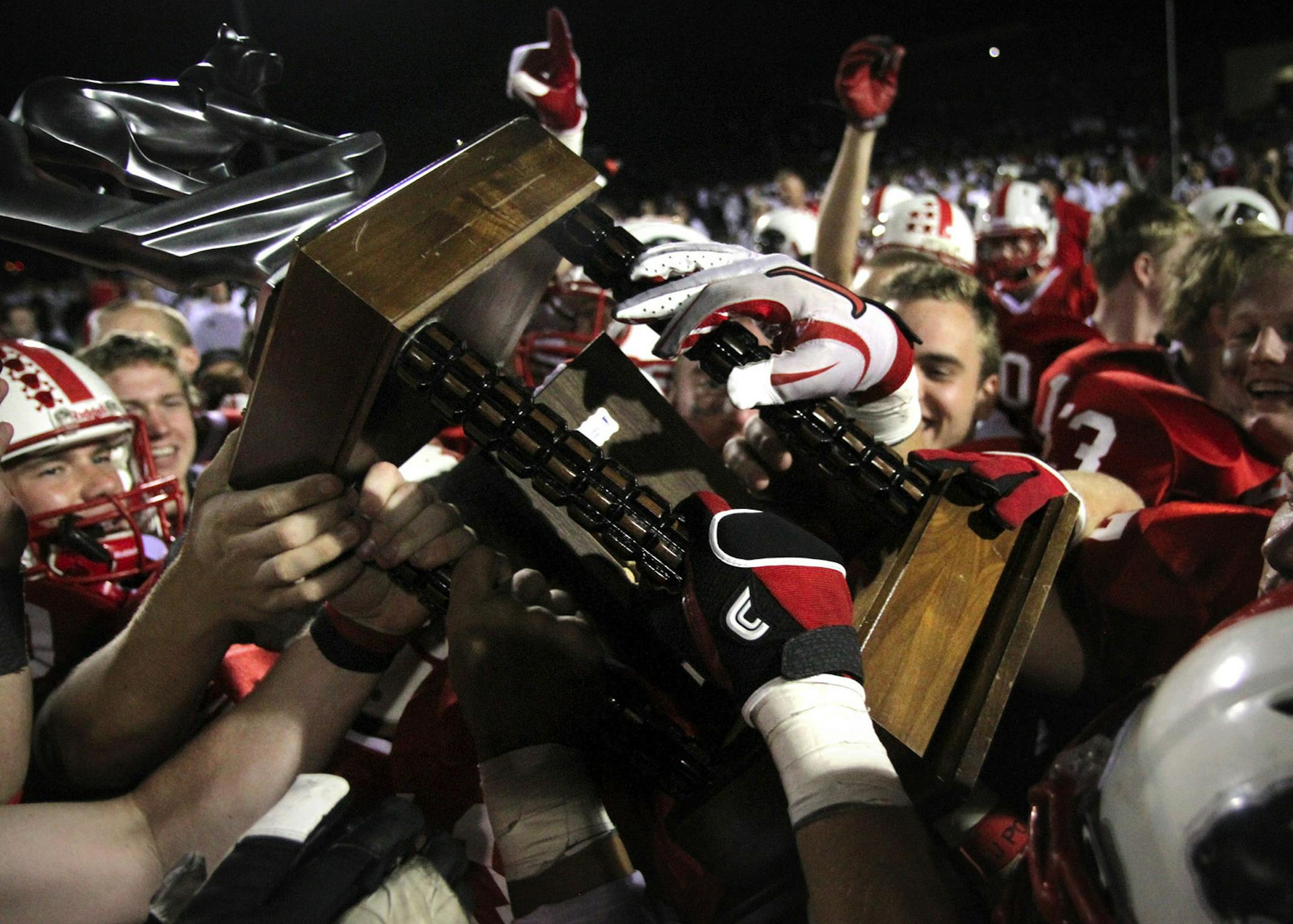 LAKEVILLE MINNESOTA 10/7/2011 The Lakeville North Panthers football team celebrate their 30-6 win over Lakeville South with the One Community Two Cats trophy they will keep for the year Friday October 7, 2011. SPECIAL TO THE STAR TRIBUNE: KATHY M. HELGESON