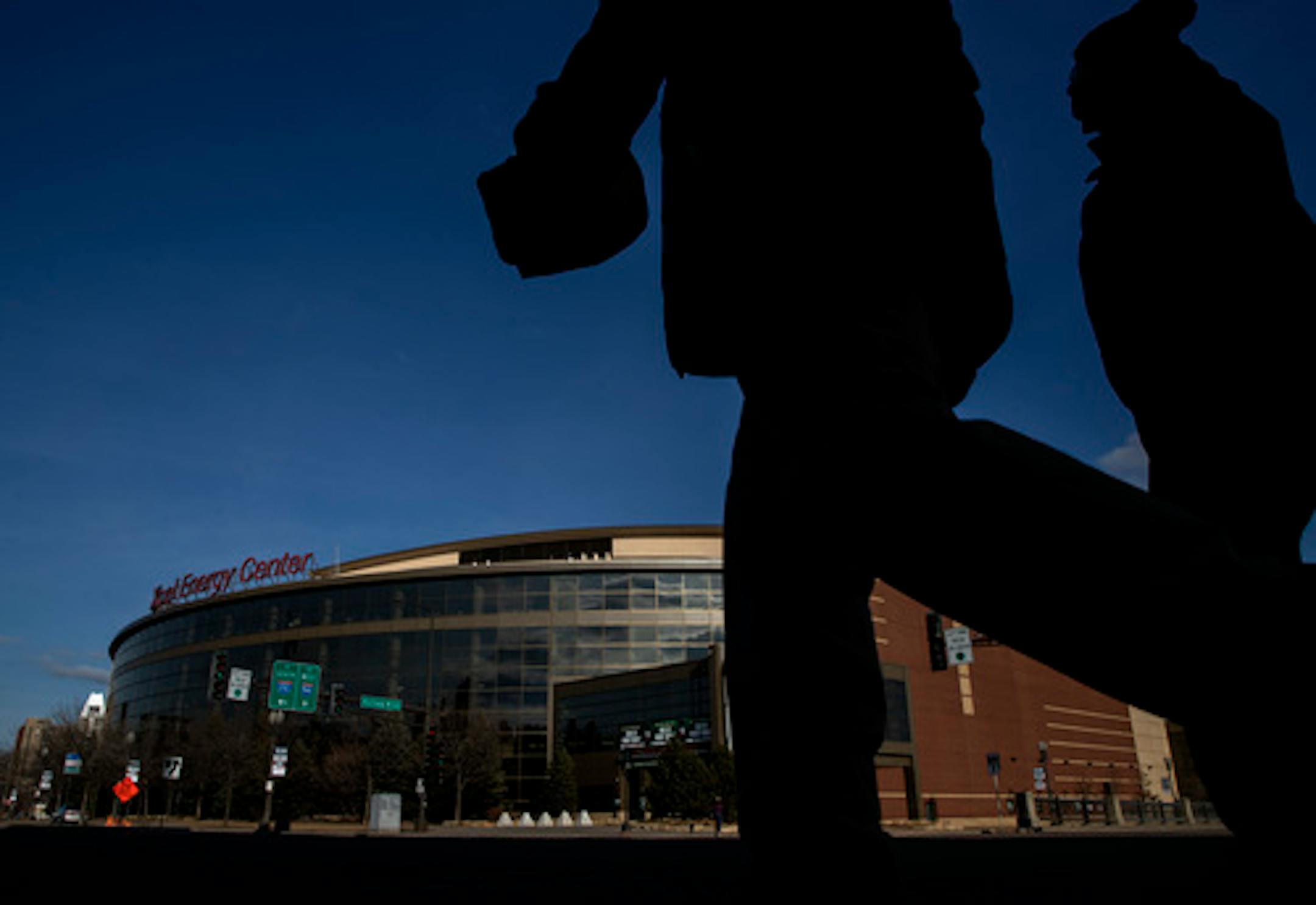 Pedestrians crossed the street in front of the Xcel Energy Center on Sunday. The Wild were scheduled to have a home game before the NHL paused the season.