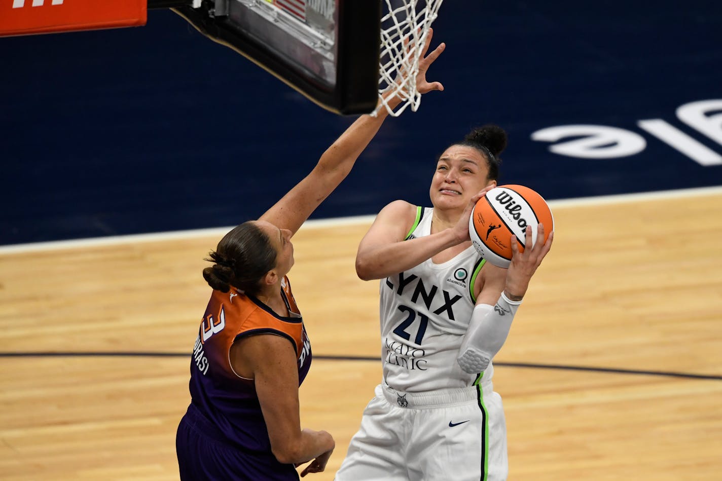 Minnesota Lynx guard Kayla McBride (21) shoots the ball against Phoenix Mercury guard Diana Taurasi (3) during a WNBA basketball game, Friday, May 14, 2021, in Minneapolis. (AP Photo/Hannah Foslien)