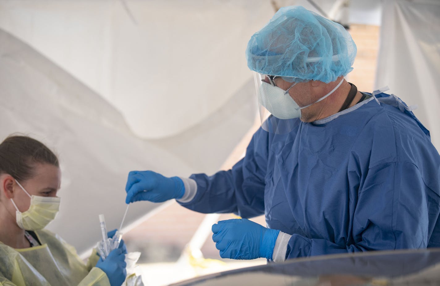 Scott Bodin, CMA, placed a nasal swab in a sterile bag after administering a drive thru COVID-19 test at the Min No Aya Win clinic on Wednesday May 6, 2020. ] ALEX KORMANN • alex.kormann@startribune.com The Min No Aya Win clinic on the Fond Du Lac reservation has seen a small amount of patients on a daily basis as they prepare for a wave of COVID-19 cases to hit their area. Dr. Vainio MD, a member of the Mille Lacs Band of the Ojibwe tribe has worked at the clinic for decades and has never seen