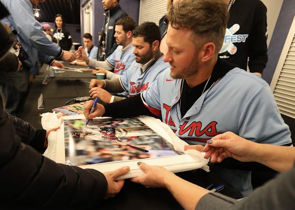 Newly signed Minnesota Twins slugger Josh Donaldson signed his autograph on a photo of himself during his time with the Atlanta Braves during TwinsFes