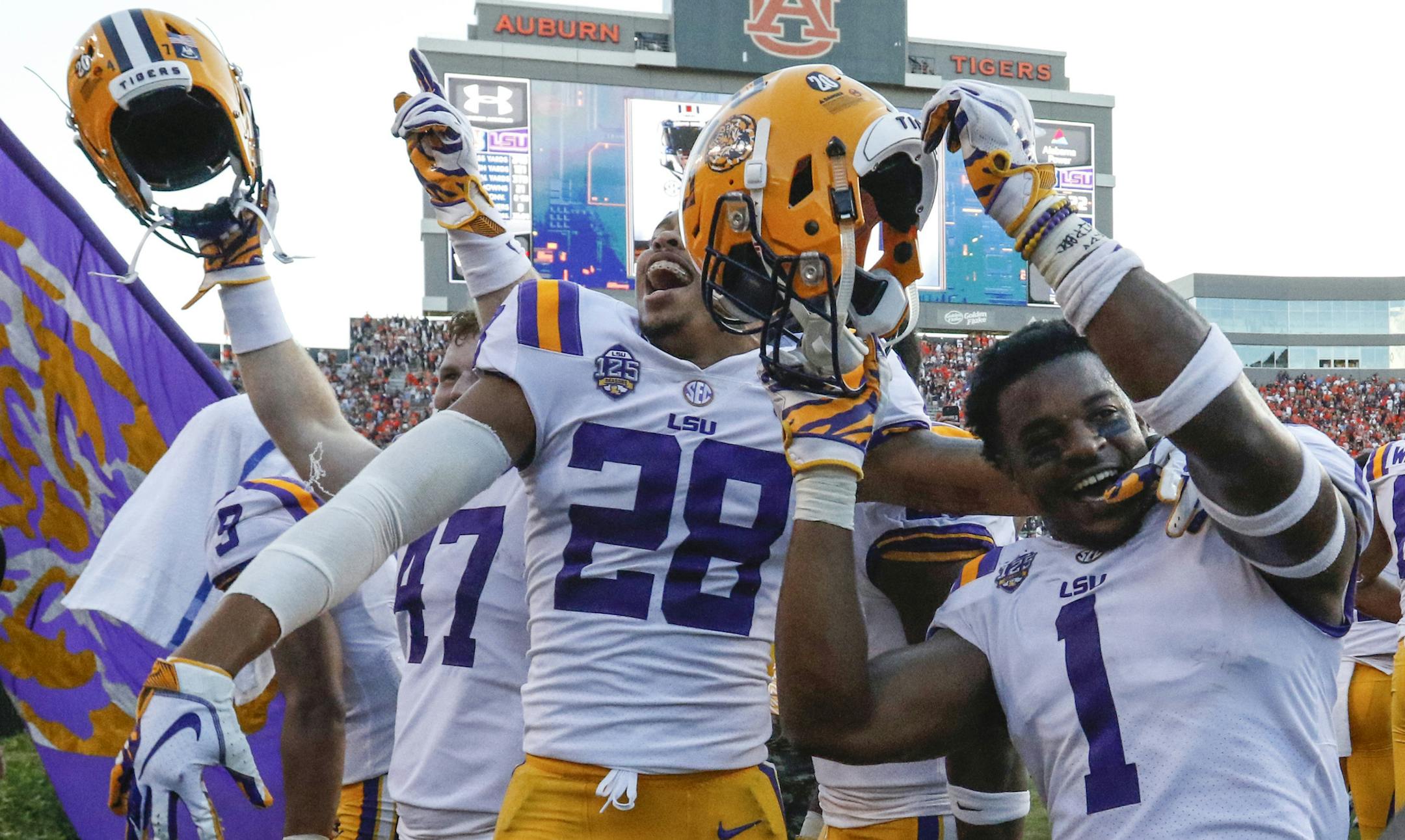 LSU players celebrate after they defeated Auburn on a last second field goal during the second half of an NCAA college football game, Saturday, Sept. 15, 2018, in Auburn, Ala. LSU won 22-21. (AP Photo/Butch Dill)