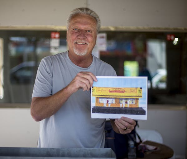 Owner Gregg Karnis poses for a portrait with a piece of concept art for the new Pronto Pups stand. ] ALEX KORMANN &#x2022; alex.kormann@startribune.co