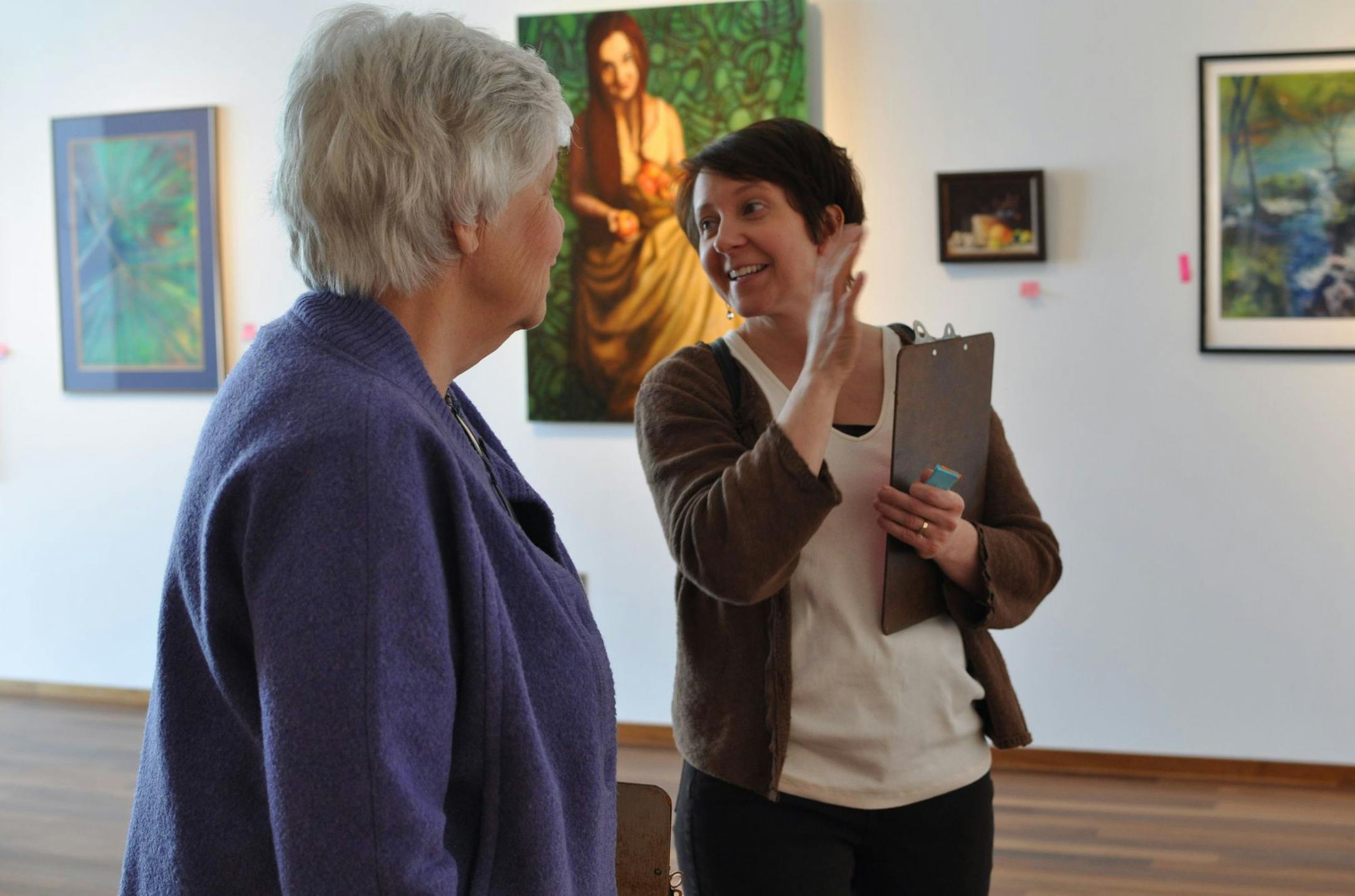 Photo by Liz Rolfsmeier Jean Loy-Swanson of St. Michael and Rachel Daly Flentje of Bloomington judge the entries in the 2013 Art Fete, now on display at the Burnsville Performing Arts Center.
