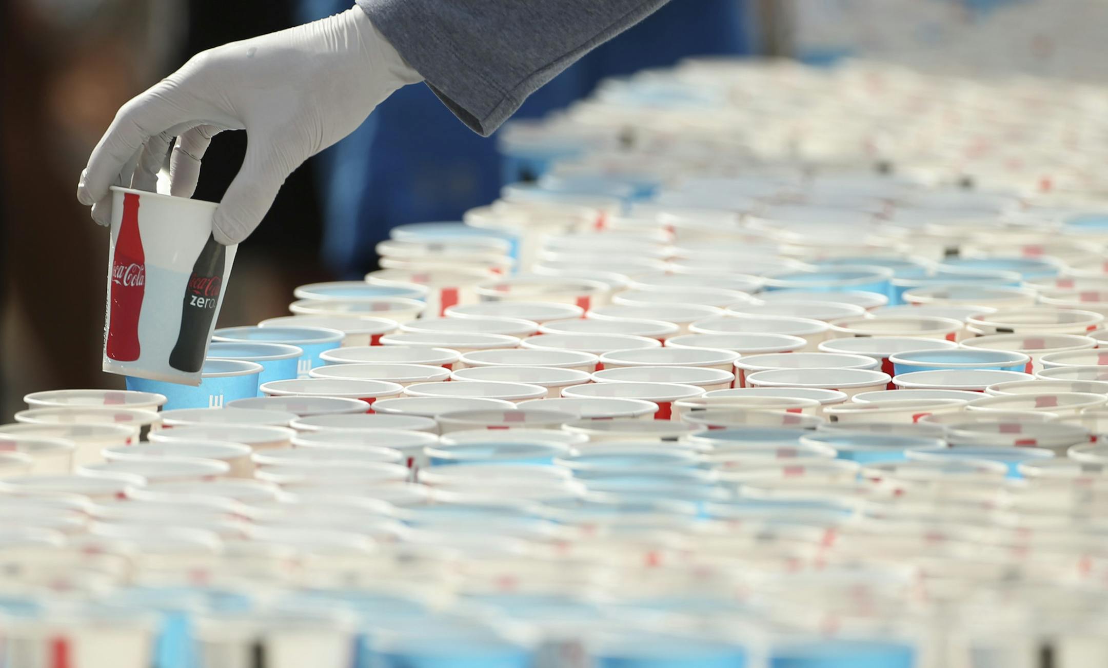 Volunteers filled cups for runners in the finishing area Sunday morning. ] JEFF WHEELER ï jeff.wheeler@startribune.com More than 11,000 runners started the Twin Cities Marathon Sunday morning, October 4, 2015 in Minneapolis.