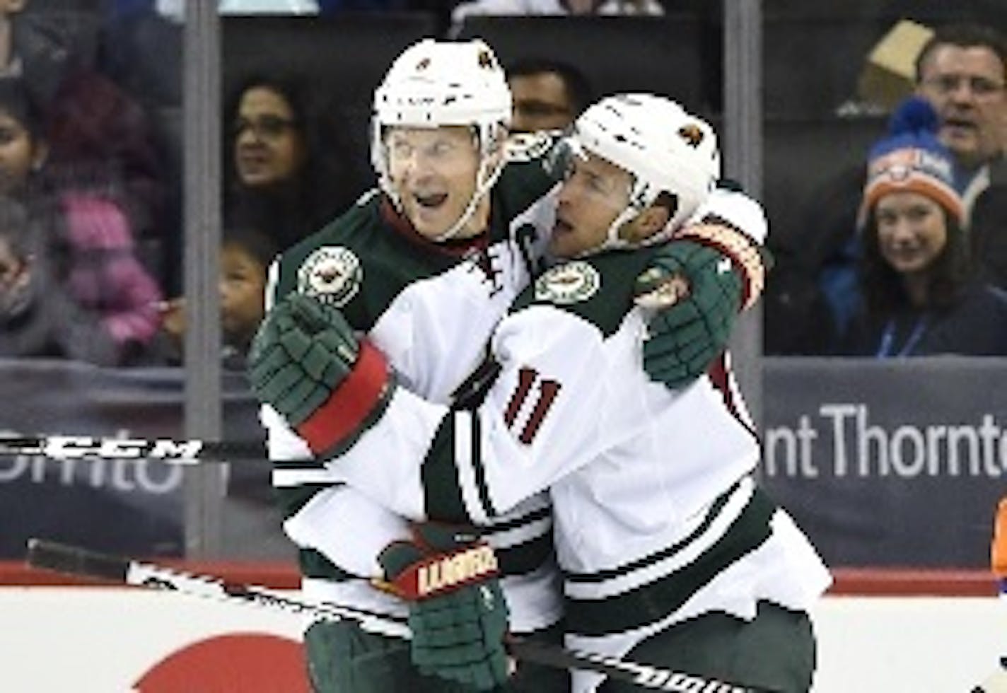 Wild center Mikko Koivu (left) and left winger Zach Parise celebrated Parise's first of two goals -- and the 300th of his NHL career -- against the New York Islanders in the second period Sunday.