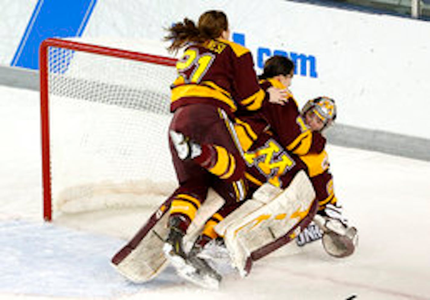 The Gophers' Dani Cameranesi (21) and Milicia McMillen jumped onto goaltender Amanda Leveille after they defeated Boston College 3-1 in the NCAA Women's Frozen Four championship game in Durham, N.H., on Sunday.