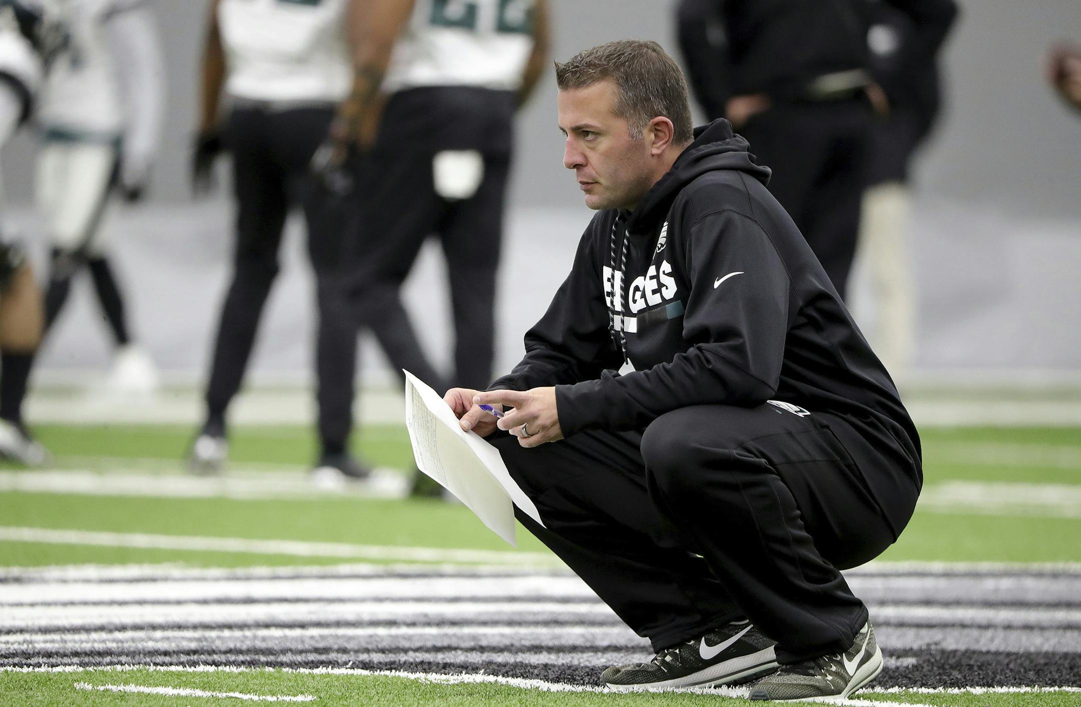 In this Jan. 3, 2018, photo, Philadelphia Eagles quarterbacks coach John DeFilippo watches the team practice in Philadelphia, Pa. The Minnesota Vikings have hired Philadelphia Eagles quarterbacks coach John DeFilippo as their offensive coordinator.