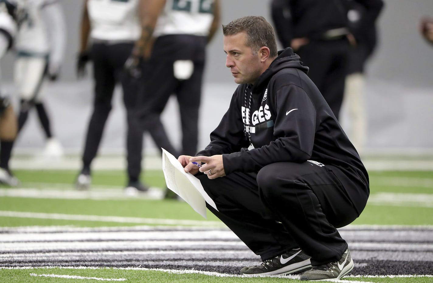 In this Jan. 3, 2018, photo, Philadelphia Eagles quarterbacks coach John DeFilippo watches the team practice in Philadelphia, Pa. The Minnesota Vikings have hired Philadelphia Eagles quarterbacks coach John DeFilippo as their offensive coordinator.