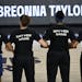 Minnesota Lynx players lock arms during a moment of silence in honor of Breonna Taylor before a WNBA basketball game against the Connecticut Sun, Sund