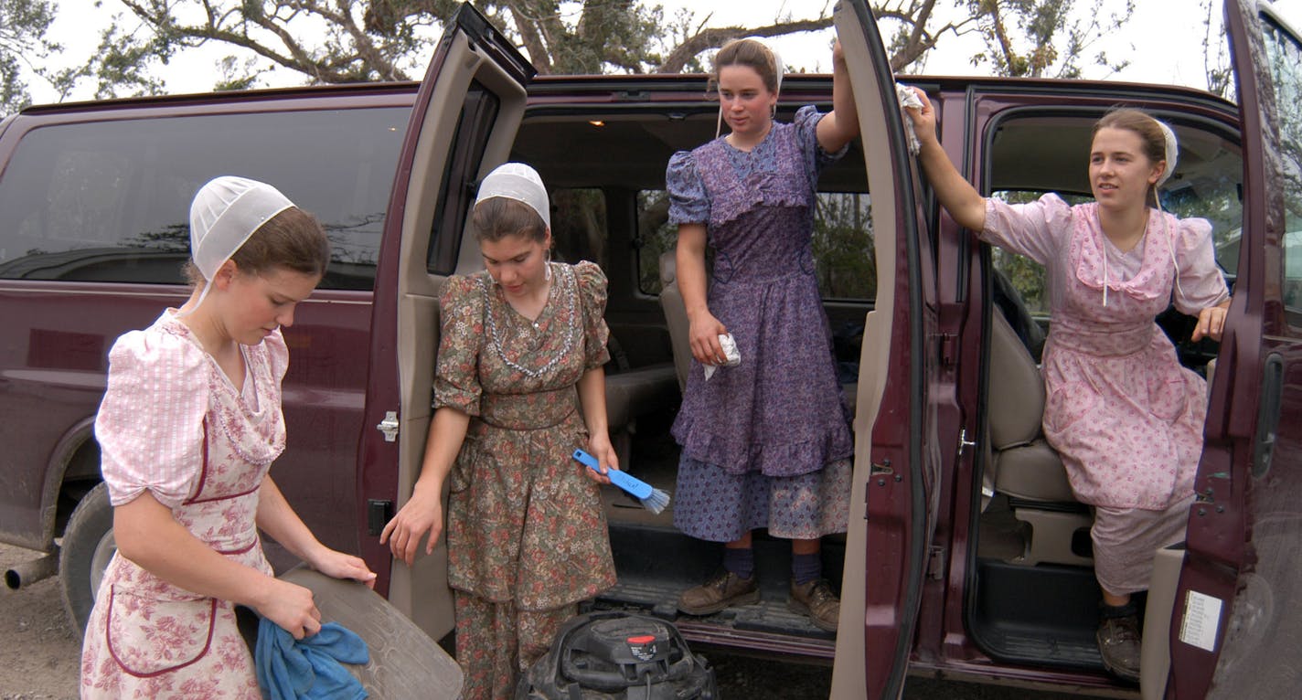 Mary Lou Weaver, Malinda Leinbach, Ellen Zimmerman and Roseanne Zimmerman, from left, all old-order Mennonites, clean a van used by a Mennonite relief group on Friday, Feb. 3, 2006 in Pass Christian, Miss. The contingent, from Lancaster, Pa., were on the Gulf Coast for a week to help with hurricane cleanup and rebuilding efforts. (AP Photo/Nicole LaCour Young) ORG XMIT: NY438