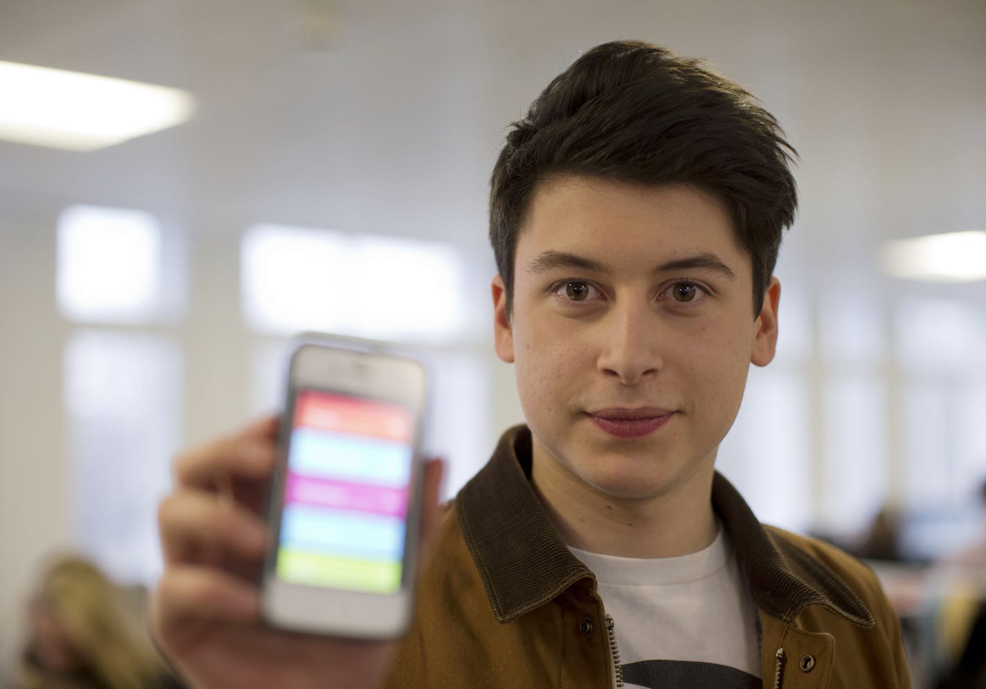Nick d'Aloisio displays his mobile application Summly, as he poses for photographs after being interviewed by the Associated Press in London, Tuesday, March 26, 2013. One of Britain's youngest Internet entrepreneurs has hit the jackpot after selling his top selling mobile application Summly to search giant Yahoo. Seventeen year old Nick d'Aloisio, who dreamed up the idea for the content shortening program when he was studying for his exams, said he was surprised by the deal. As with its other re
