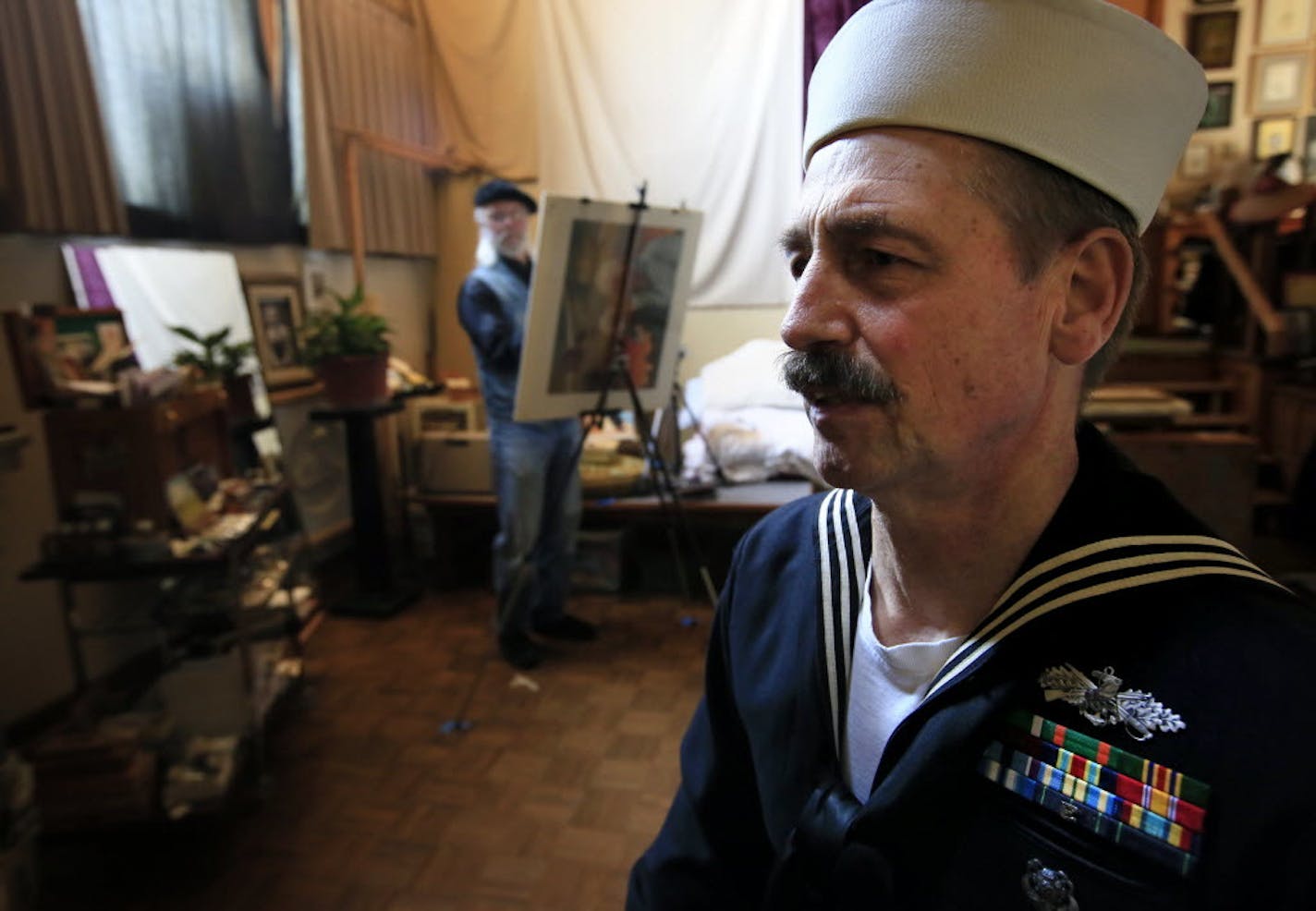 Ray Stumpf, posed as the model for "the lone sailor" in one of Charles Kapsner's military paintings.