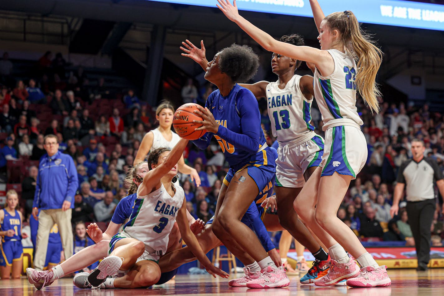 Eagan defenders came at JaKahla Kraft from all directions, but Kraft managed to lead St. Michael-Albertville in scoring with 24 points. , surrounded by Eagan defenders, went back to the basket after collecting her own rebound. Kraft scored 24 points in St. Michael-Albertville's 80-60 victory at Williams Arena. Class 4A girls basketball state tournament quarterfinal, Eagan vs. St. Michael-Albertville, 3-15-23. Photo by Mark Hvidsten, SportsEngine