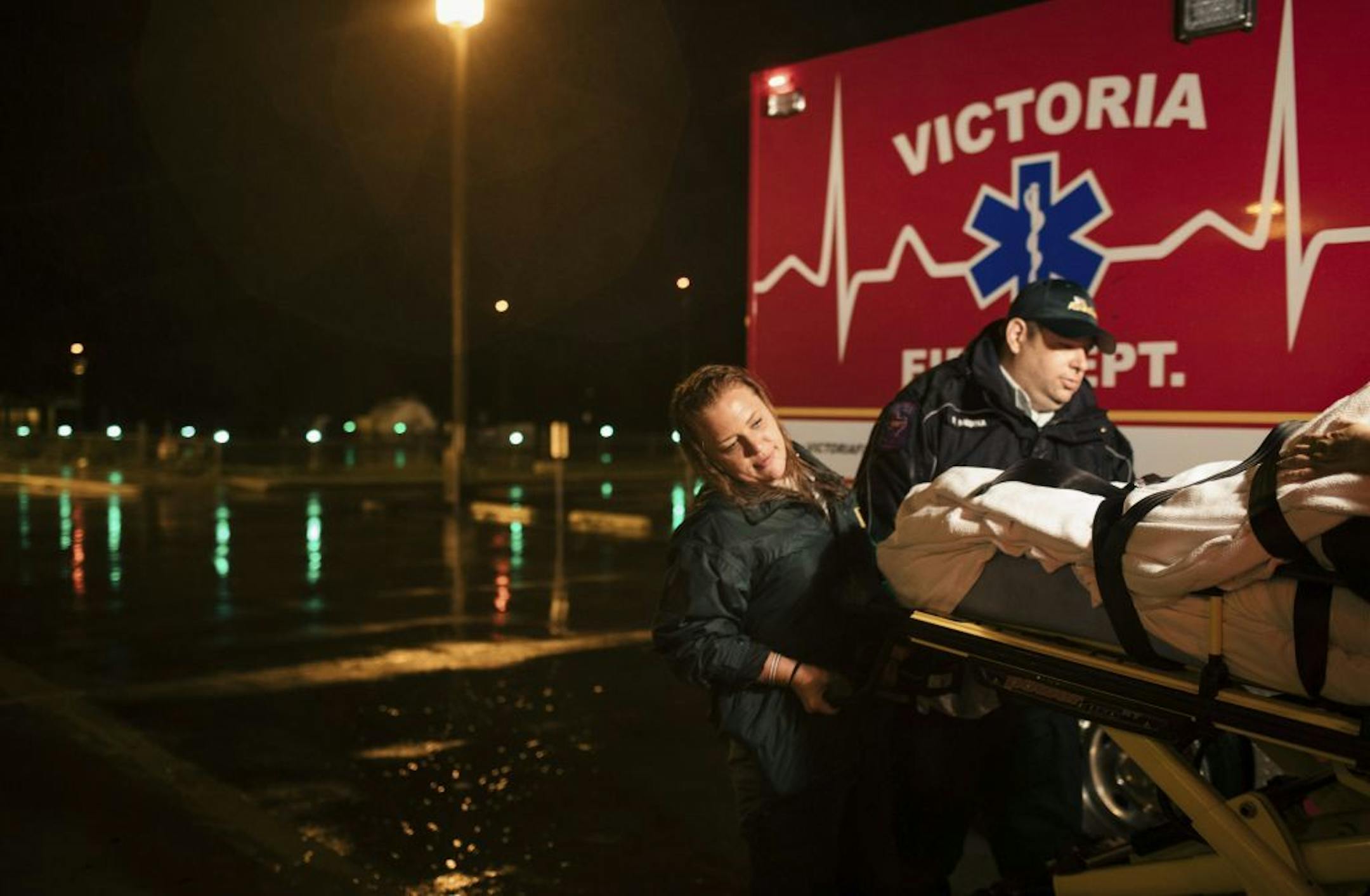Jami Leifeste, an emergency medical technician, is helped by a co-worker as they evacuate a patient from Citizens Medical Center to another hospital, in Victoria, Texas, Aug. 26, 2017. Houston�s world-renowned health care infrastructure found itself battered by Hurricane Harvey, testing whether officials had done enough to prepare.