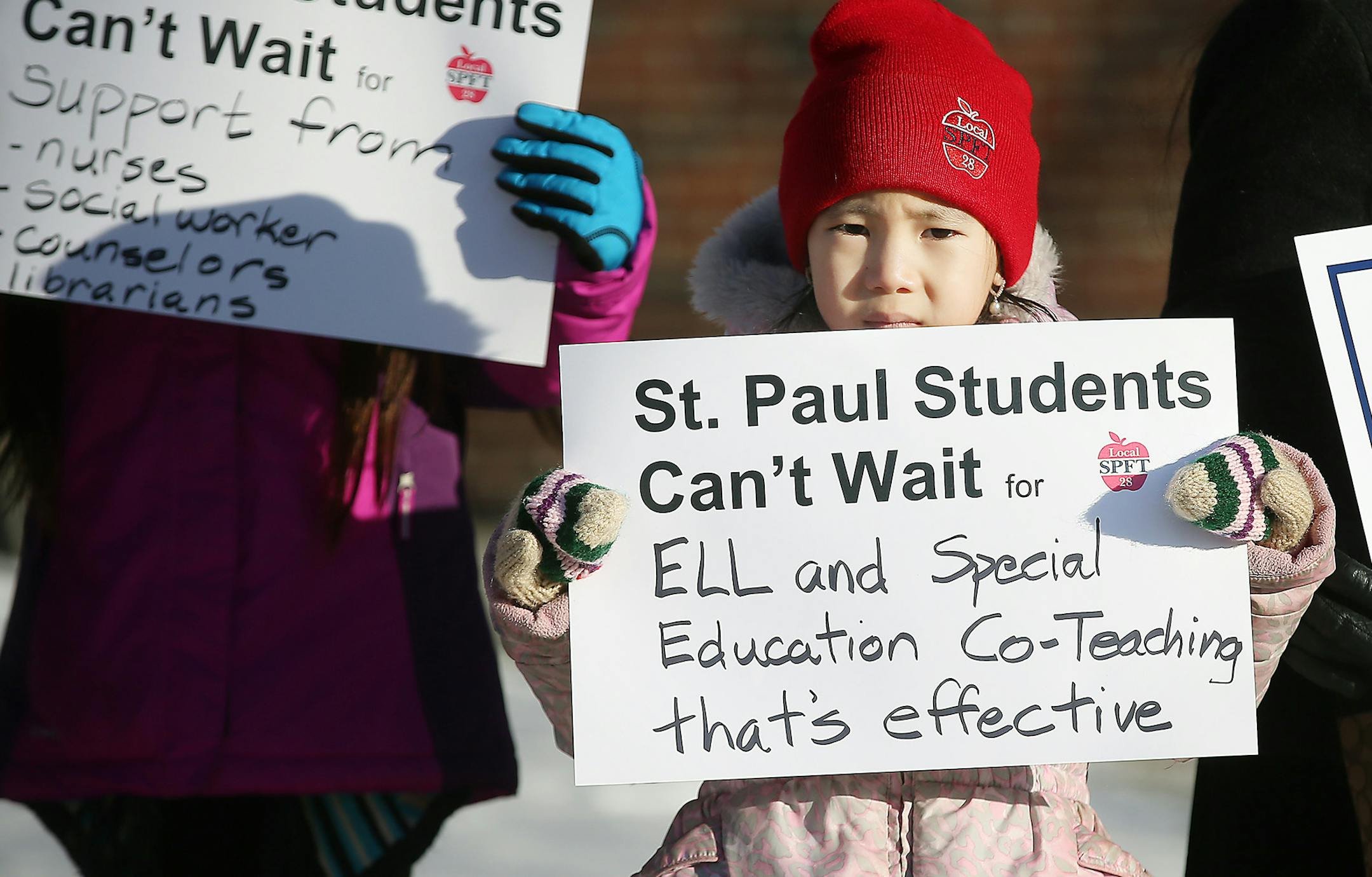 Gaoshiaxa Cha, 7, cq, stood alongside her mother Maysy Ly-Lo, cq, an ELL Education Assistant, to support the St. Paul teachers union as they gathered at the American Indian Magnet School for a rally, Wednesday, February 17, 2017 in St. Paul, MN. ] (ELIZABETH FLORES/STAR TRIBUNE) ELIZABETH FLORES • eflores@startribune.com