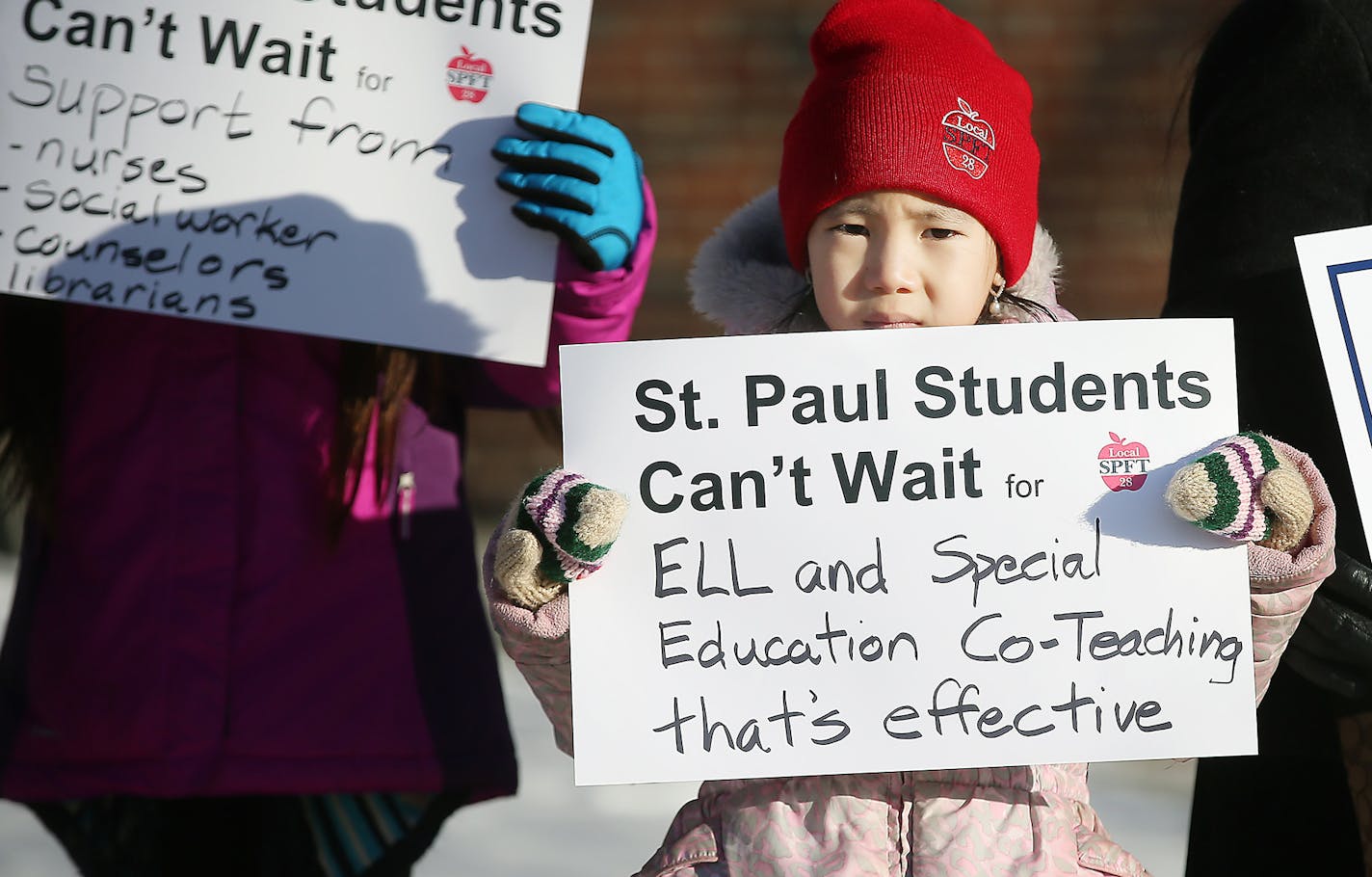 Gaoshiaxa Cha, 7, cq, stood alongside her mother Maysy Ly-Lo, cq, an ELL Education Assistant, to support the St. Paul teachers union as they gathered at the American Indian Magnet School for a rally, Wednesday, February 17, 2017 in St. Paul, MN. ] (ELIZABETH FLORES/STAR TRIBUNE) ELIZABETH FLORES &#x2022; eflores@startribune.com