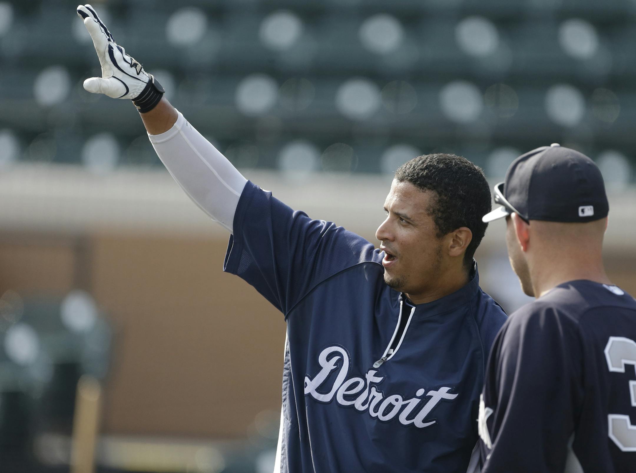 Detroit Tigers designated hitter Victor Martinez talks with New York Yankees third baseman Kevin Youkilis before an exhibition spring training baseball game, Saturday, March 23, 2013 in Lakeland, Fla. (AP Photo/Carlos Osorio)