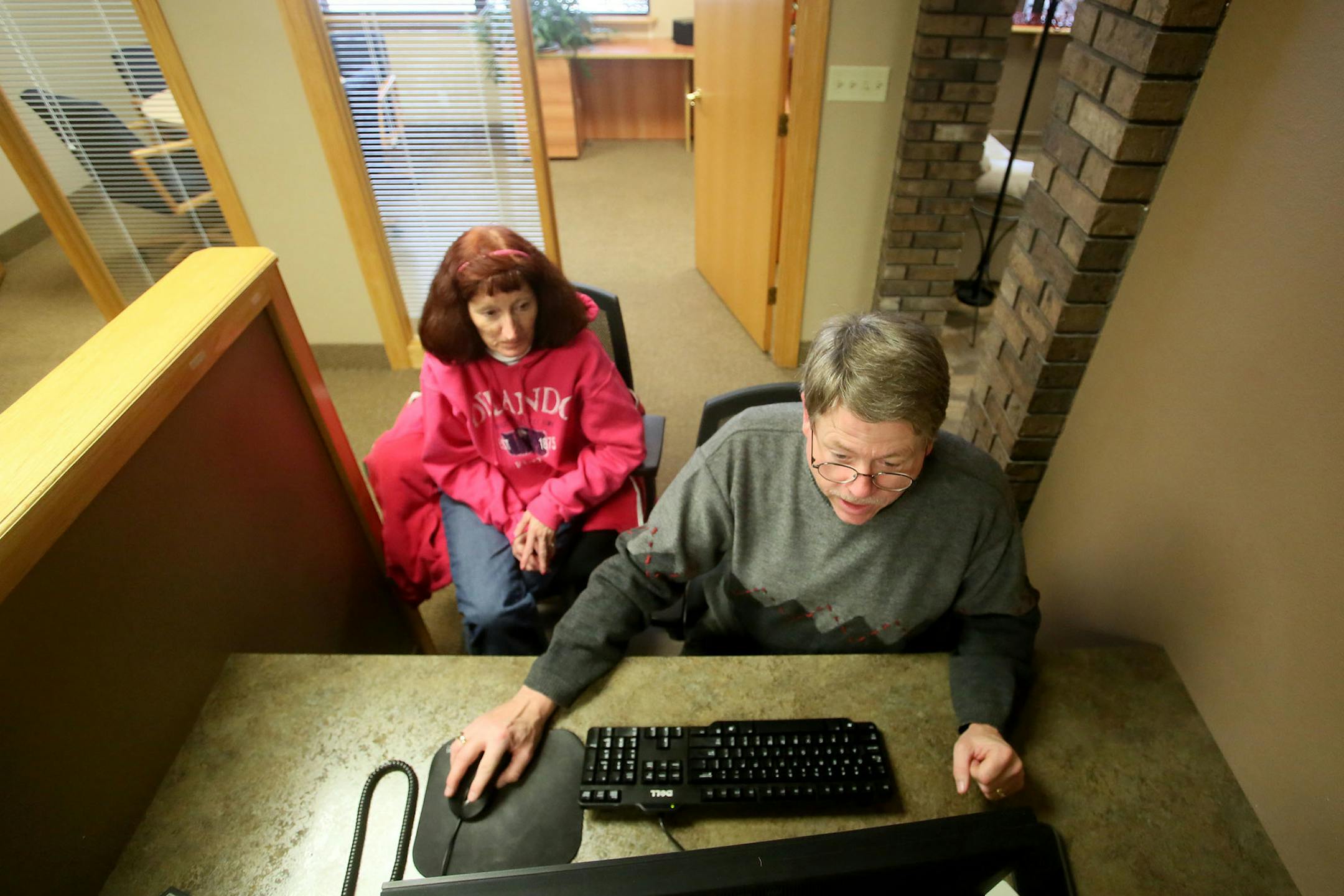 Paul Sigurdson, an agent at Counselor Realty, walked client Barb Blubaugh of Columbia Heights through the TLCengine at his Fridley office on Dec. 20.