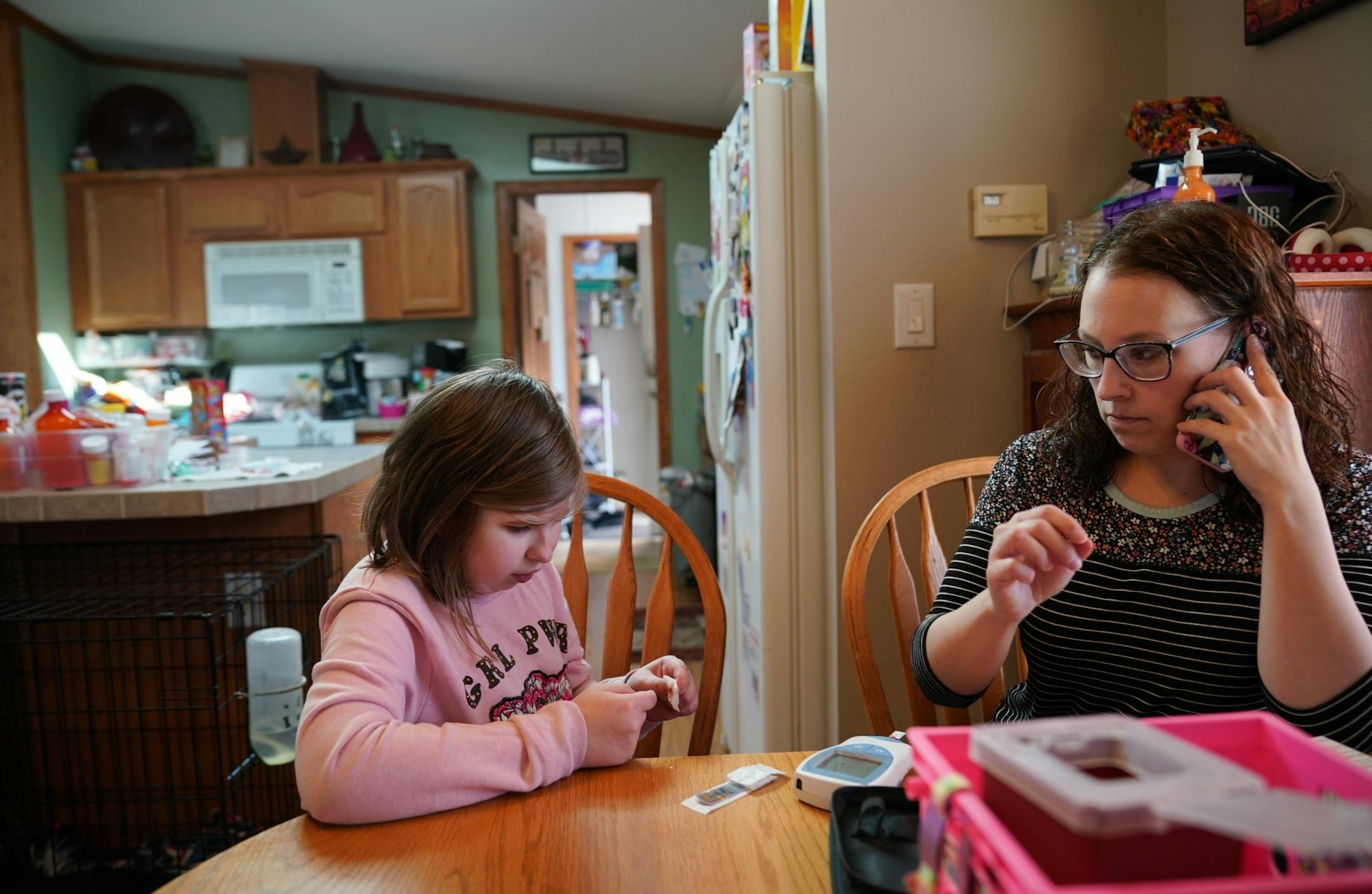 Linsey Rippy tested Madi's blood with a small stick and a blood test. She then called the results into her doctor at the Mayo Clinic. The INR test measures the thinness of Madi's blood, necessary after her heart transplant. Madi is 12.