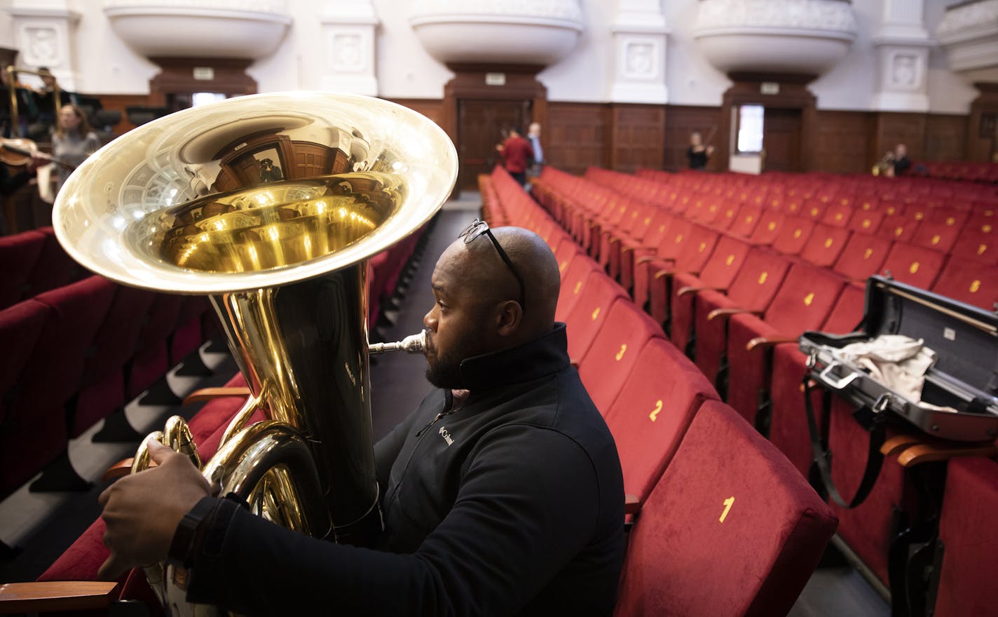 Tuba player Jason Tanksley warms up in the audience seats a few hours before the Minnesota Orchestra's concert at City Hall in Cape Town, South Africa.