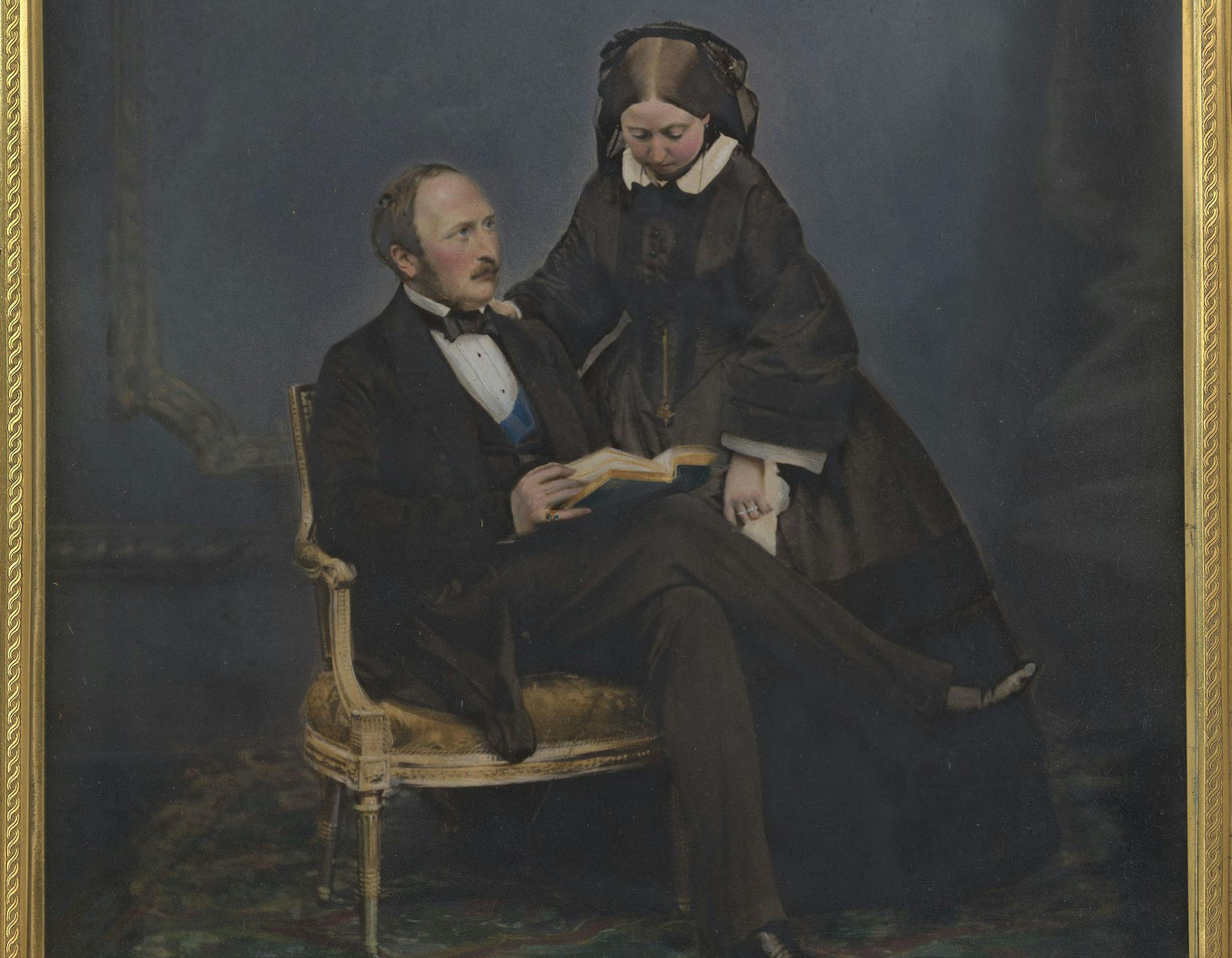 This image issued on Friday Aug. 23, 2019 by The Royal Collection shows a photograph of Queen Victoria and Prince Albert, 1860. In John Jabez Edwin Mayall's portrait of 1860, the Queen stands dutifully at her seated husband's side, her head bowed. This little-known version of the photograph, hand coloured and presented in a custom frame, was taken a year before Albert's untimely death in 1861. British royal documents, including images of Victoria’s leather-bound notebook, have been upload
