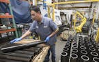 Thao Nguyen (cq) an employee at Graco, and stacked tubes of carbon steel Monday March 12, 2018 in Minneapolis, MN.] JERRY HOLT &#xef; jerry.holt@start
