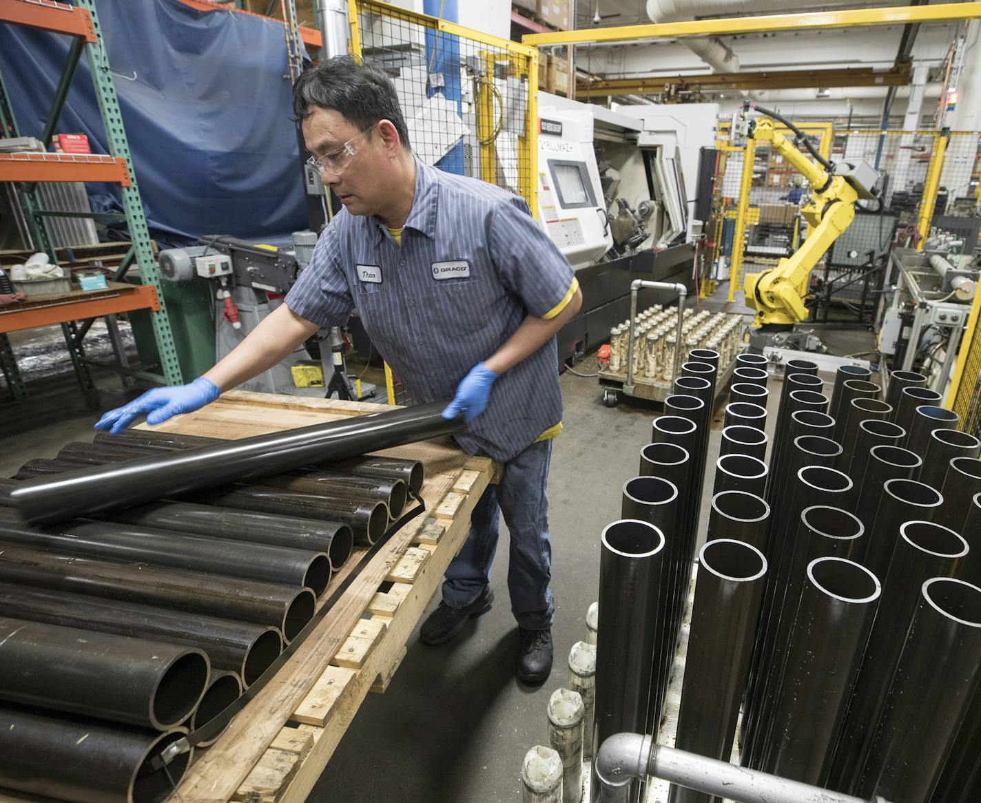 Thao Nguyen (cq) an employee at Graco, and stacked tubes of carbon steel Monday March 12, 2018 in Minneapolis, MN.] JERRY HOLT &#xef; jerry.holt@startribune.com