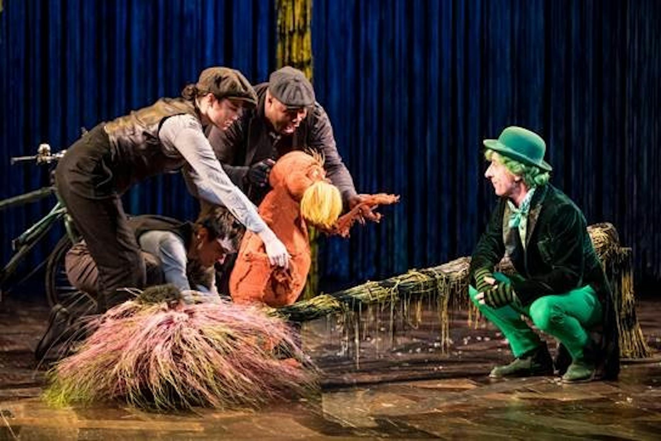 The Lorax — with puppeteers Meghan Kreidler, Rick Miller and H. Adam Harris — faces off against the Once-ler (Steven Epp) in "Dr. Seuss's The Lorax" at Children's Theatre Company.