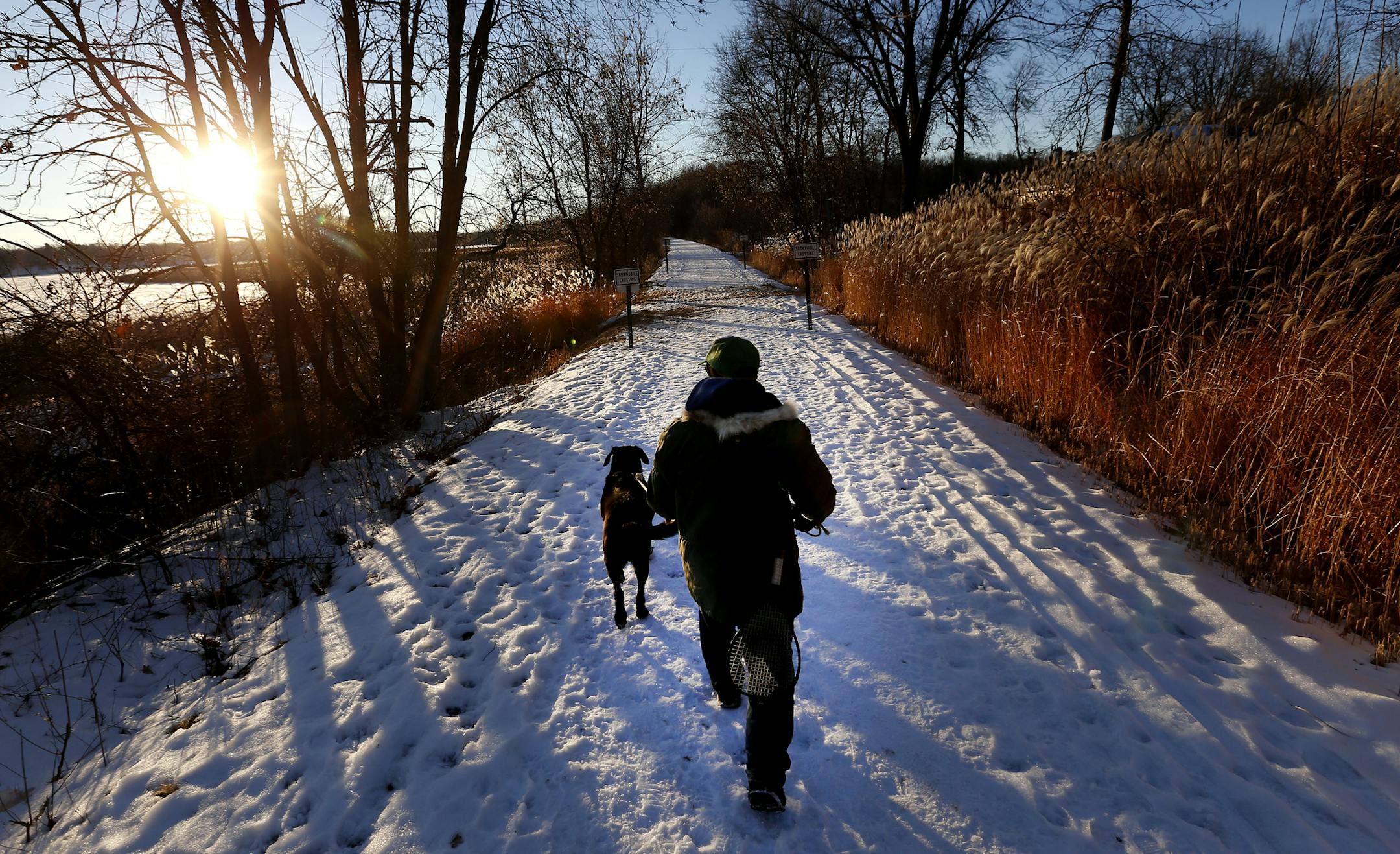 Clark Peters of Mound walked his black lab Brady along the Dakota Rail Regional Trail in Mound on Sunday. Peters uses the trail daily. ] CARLOS GONZALEZ cgonzalez@startribune.com, January 18, 2015, Minnetonka, Minn., Dakota Rail Regional Trail, which is a popular Three Rivers Park trail.
