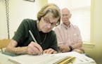 FILE-- Janice Ryan signs a living will and health care proxy form with her husband, Richard, in Dundee, N.Y., July 23, 2014. After years of debate abo