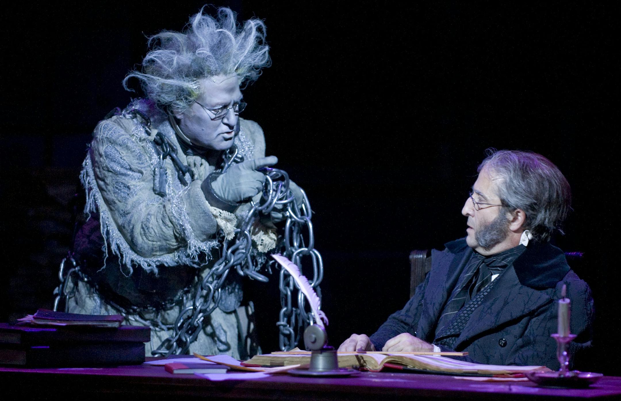 Bob Davis (Jacob Marley) and J.C. Cutler (Ebenezer Scrooge) in the Guthrie Theater's production of the Charles Dickens classic A Christmas Carol, adapted by Crispin Whittell and directed by Joe Chvala with set design by Walt Spangler, costume design by Mathew J. LeFebvre and lighting design by Christopher Akerlind. November 14 - December 29, 2013, on the Wurtele Thrust Stage at the Guthrie Theater, Minneapolis. Photo by Michael Brosilow
