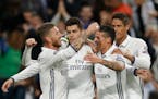 Real Madrid players celebrate with Alvaro Morata, second left, who scored 2-1 during a Champions League, Group F soccer match between Real Madrid and 
