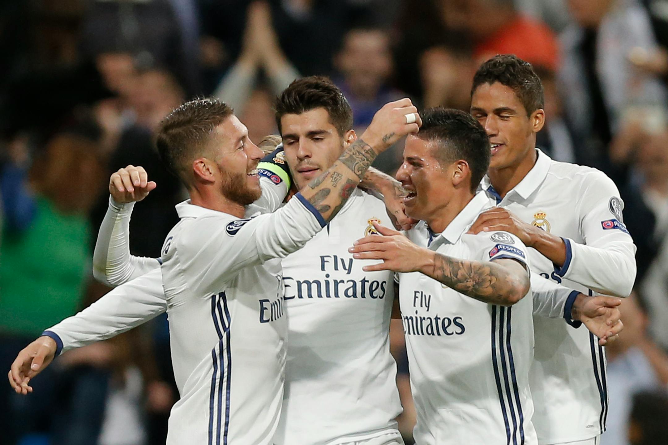 Real Madrid players celebrate with Alvaro Morata, second left, who scored 2-1 during a Champions League, Group F soccer match between Real Madrid and Sporting, at the Santiago Bernabeu stadium in Madrid, Spain, Wednesday, Sept. 14, 2016. (AP Photo/Daniel Ochoa de Olza)