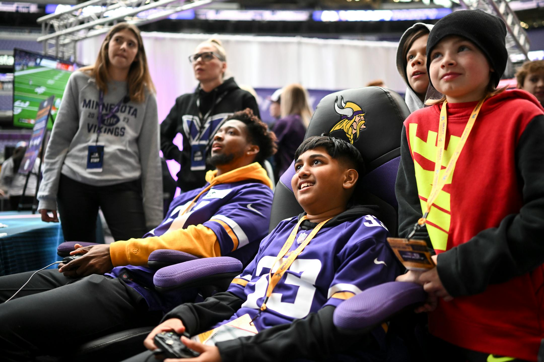Peyton Kissoondath, of Golden Valley, plays Madden on the Xbox with Minnesota Vikings cornerback Akayleb Evans during the Vikings NFL Draft Party.
