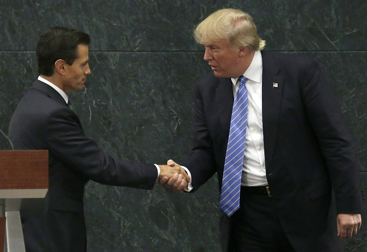 Mexico President Enrique Pena Nieto and Republican presidential nominee Donald Trump shake hands after a joint statement at Los Pinos, the presidential official residence, in Mexico City, Wednesday, Aug. 31, 2016. Trump is calling his surprise visit to Mexico City Wednesday a 'great honor.' The Republican presidential nominee said after meeting with Pena Nieto that the pair had a substantive, direct and constructive exchange of ideas.v(AP Photo/Marco Ugarte)