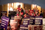 Demonstrators supporting and opposing abortion rights protest outside the state House Chamber in January in St. Paul.