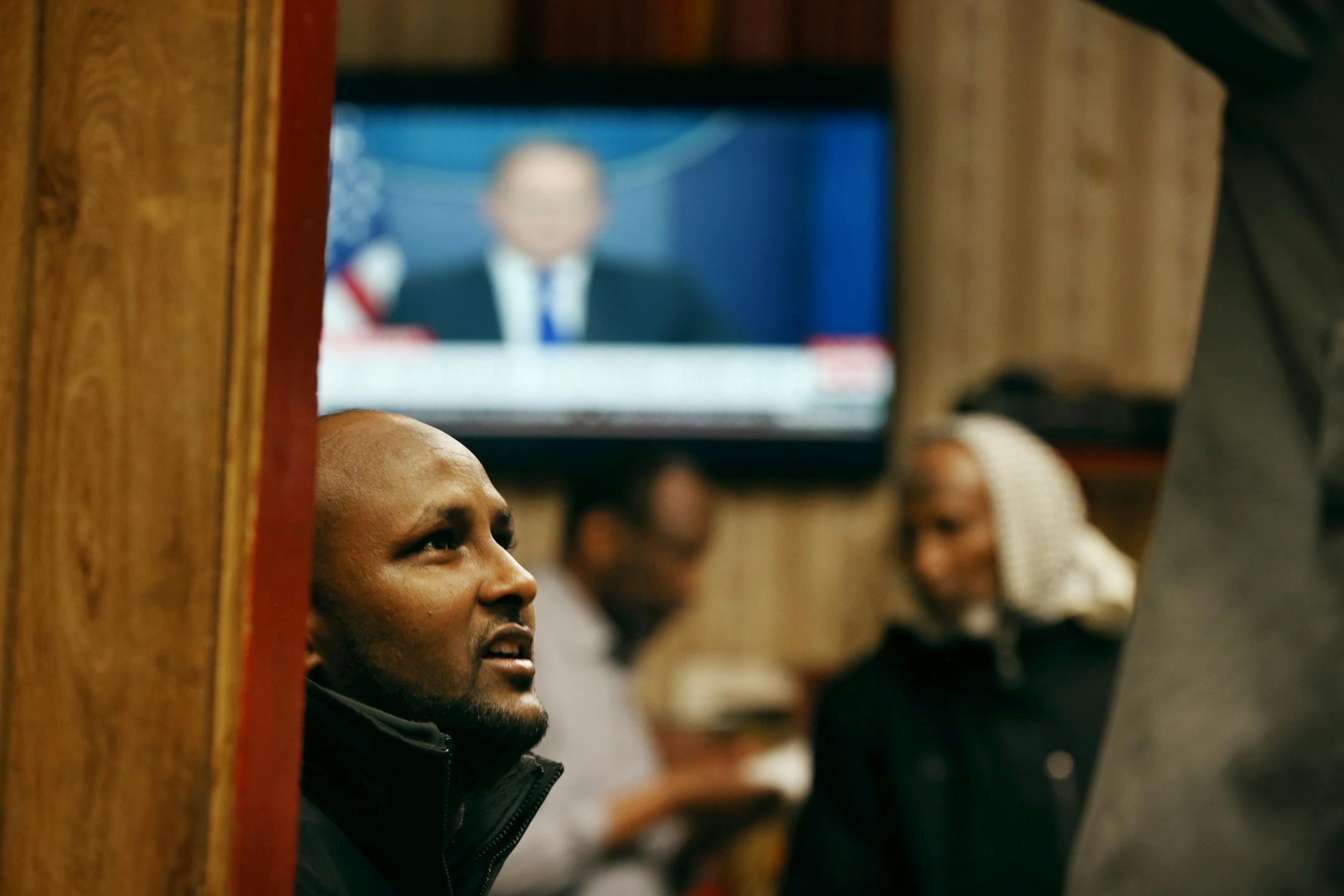 Mahdi Ali and other Somali men watched White House press secretary Sean Spicer on CNN as they sipped tea at a restaurant Wednesday Feb 1, 2017 in Faribault, MN.