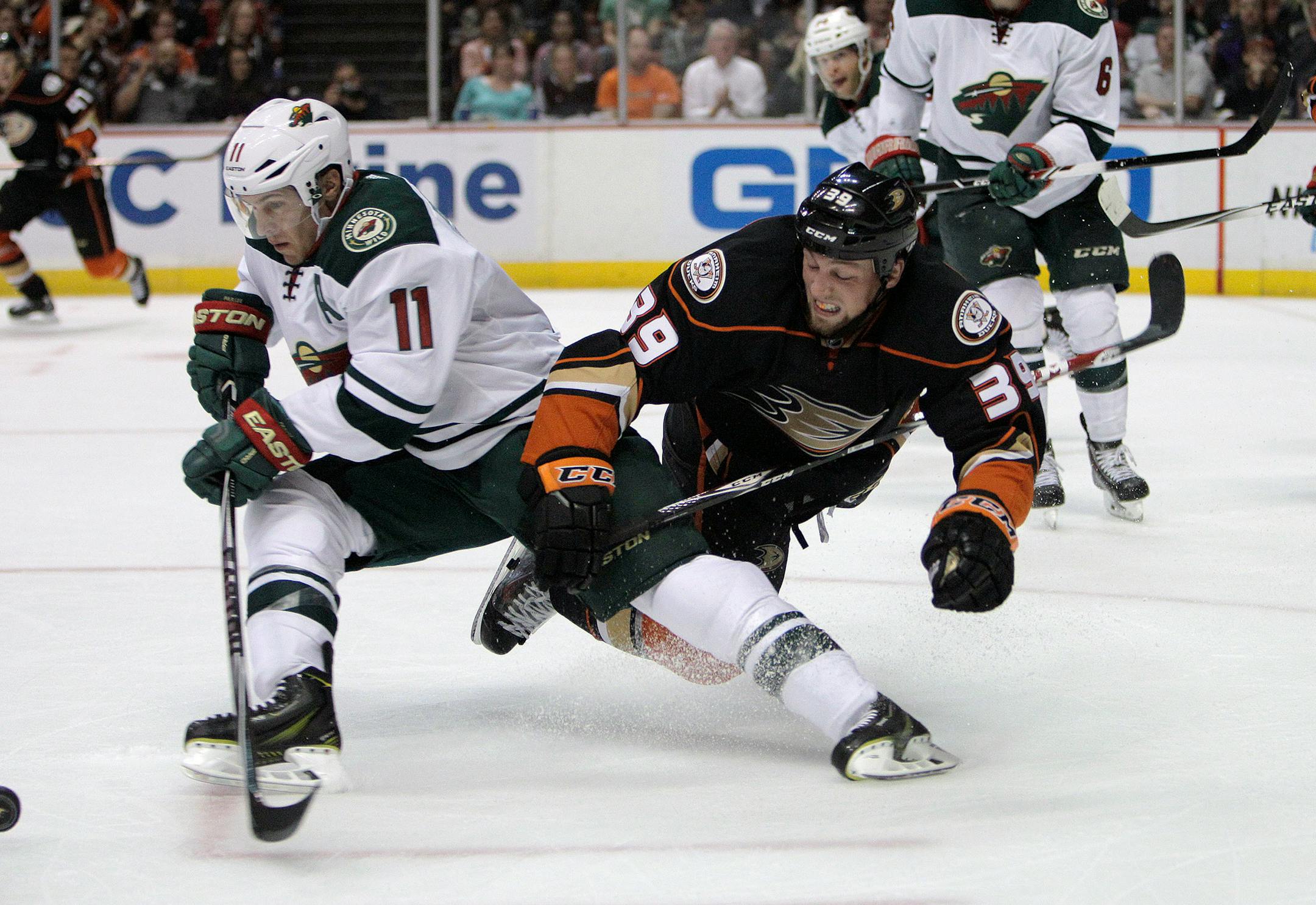 The Minnesota Wild Zach Parise (11) clears the puck from the Anaheim Ducks' Matt Beleskey (39) in the second period at Honda Center in Anaheim, Calif., on Friday, Oct. 17, 2014. (Gina Ferazzi/Los Angeles Times/MCT) ORG XMIT: 1158847