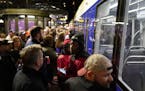 Fans wait in long lines after the game for the light rail train at the Government Center station in downtown Minneapolis.