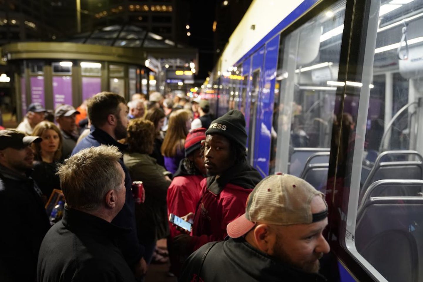 Fans wait in long lines after the game for the light rail train at the Government Center station in downtown Minneapolis.